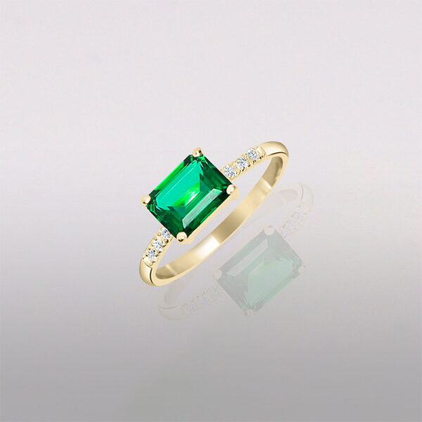 Emerald 14k gold engagement ring with side diamond