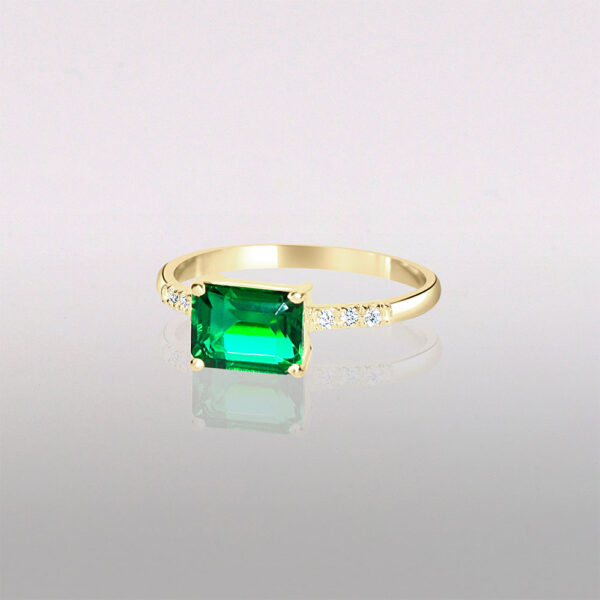 Emerald 14k gold engagement ring with side diamond