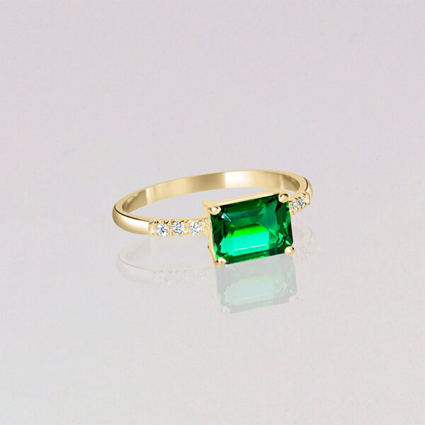 Emerald 14k gold engagement ring with side diamond